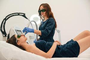 Professional, occupation.. Getting photo rejuvenation procedure at cosmetology clinic. Women in beauty salon