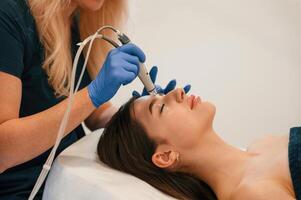 Procedure on the face.. Getting photo rejuvenation at cosmetology clinic. Women in beauty salon