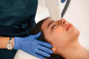 Getting photo rejuvenation procedure at cosmetology clinic. Woman is getting LPG hardware massage in beauty salon
