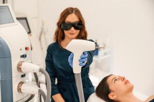 Getting photo rejuvenation, procedure at cosmetology clinic. Woman is getting LPG hardware massage in beauty salon