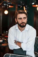 Handsome man with, beard is in the barber shop photo