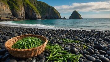 A basket of green beans on a rocky beach with cliffs and ocean waves in the background. photo
