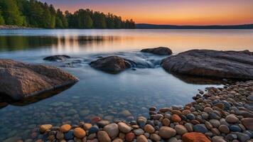 Tranquil lakeside scene at sunset with smooth stones and gentle water flow. photo
