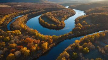 Aerial view of a winding river surrounded by vibrant autumn foliage. photo
