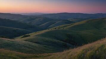 Serene landscape with rolling hills and a colorful sunset sky. photo