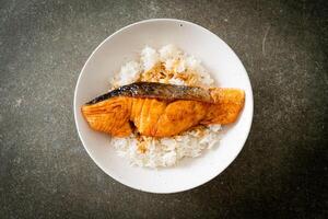 Grilled Salmon with Soy Sauce Rice Bowl in japanese style on dark background photo