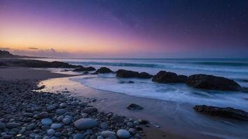 Stony Beach at Dusk Waves Washing Ashore Under Starry Sky photo