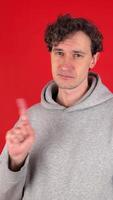 serious man shakes index finger hand in front showing sign ban, rejected gesture. Isolated red background studio shot. Concept - avoid, danger, disapproval, negative emotions, must not, impossible. video