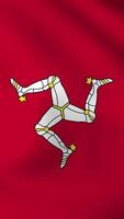 Vertical, portrait waving national flag of Isle of Man. Smooth animation with highly detailed, realistic animated background for social media, screens smartphone. Cloth motion, official colors. video