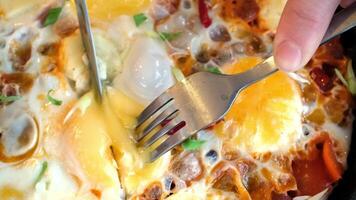 Close-up of baked eggs with melted cheese and vegetables video