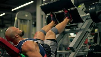 athletic man beard performs leg exercises in modern gym. His focused workout routine emphasizes strength and leg development during training session video