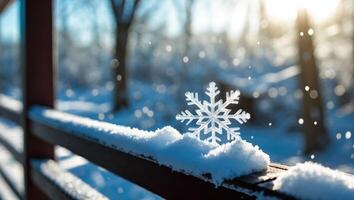 Snowflake on Snowy Railing in Winter Sunlight with Bokeh Effect photo
