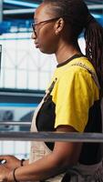 Vertical Portrait of happy engineer in photovoltaics smart factory analyzing data, reviewing system metrics. Cheerful woman in industry 4.0 solar panels plant producing renewable energy, camera A video