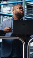 vertical inteligente fábrica Gerente discutindo com empregados automatizado fluxo de trabalho implementação. Supervisor supervisionando industrial plantar fala com trabalhadores, integrando sensores para dentro Produção, Câmera uma video