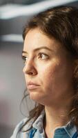 Vertical Close up of woman sitting at office desk, solving tasks during job shift. Office clerk doing email communication in workplace, researching data for company project, camera A video