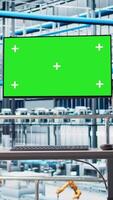 Vertical Green screen monitor displaying analytics dashboard for Industry 4.0 smart factory equipment. Industrial plant mockup display visualizing robotic arms performance and metrics from sensor data video