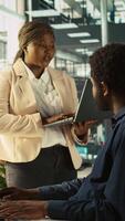 Vertical Manager in office ensuring worker hits key performance targets for revenue, profitability and operational efficiency. Corporate management executive board member talks with employee at work, camera B video