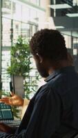 Vertical Angry manager in office berating worker for not hitting revenue key performance targets. Upset management executive fighting with employee at work scolding him for low output, camera B video