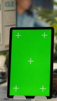 Vertical Close up of isolated screen tablet used by worker in office reviewing financial graphs. Employee looking over data trends and strategic insights on mockup tablet, analyzing KPIs, camera A video