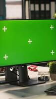 Vertical Green screen PC in office used by employee working on company administrative tasks. Mockup computer display on desk used by worker reviewing business data metrics, camera A video