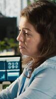 Vertical Stressed worker in office sighs, burdened by too many documents to review. Tired employee at work feeling overworked while analyzing business performance metrics, camera A video