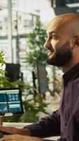 Vertical Startup staff member working to hit key performance targets for revenue, profitability and operational efficiency. Employee at computer desk doing research analysis, camera B close up video