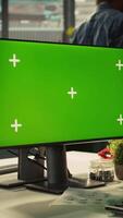 Vertical Office clerk working on green screen mockup PC to hit key performance targets for revenue and profitability. Employee at chroma key computer desk doing research analysis, camera B video
