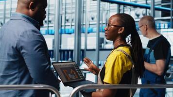 Engineers meeting with smart factory investor, showing insights based on collected data. Specialists discussing with industrial plant shareholder, presenting metrics gathered by sensors, camera A video