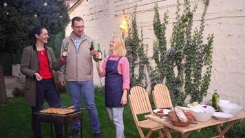 Enjoying a backyard gathering with friends, grilling and sharing laughter on a warm evening video