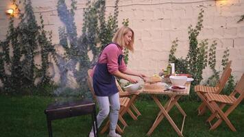 Enjoying a sunny afternoon grilling as friends gather around a lush backyard setting video