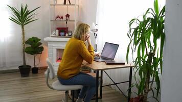 Working from home in a cozy and modern workspace with a touch of greenery and warmth video