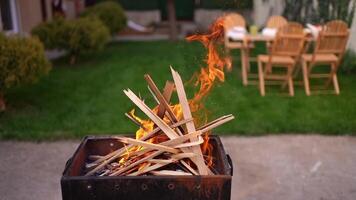 Captivating flames dance in a backyard setting during a cozy gathering at dusk video