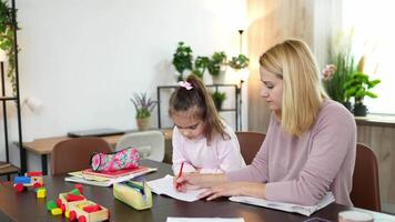 Engaging in creative learning at home with a parent and child during afternoon study time video