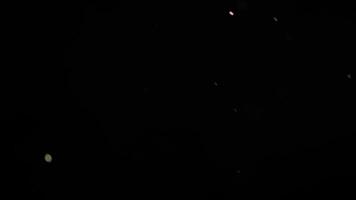 Few Chaotic Real Dust Particles Floating On Black Background video