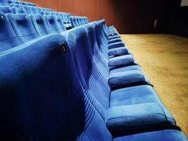 Empty rows of seats in the hall for a large number of people. Cinema and theatre hall for watching performances photo