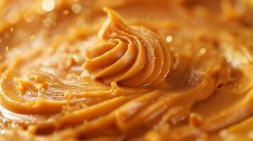 Close-up of creamy, smooth peanut butter with a glossy texture. photo