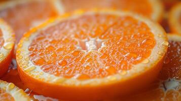 Close-up of vibrant orange slices glistening with droplets of water. photo