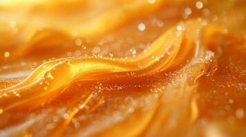 A close-up view of shimmering orange waves with sparkling droplets, creating an abstract and vibrant texture. photo