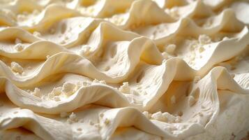 Close-up of a delectable dessert featuring creamy, textured frosting and delicate crumbs. photo