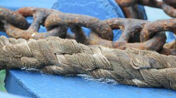 Very large ferry ropes are used to tie up ships when they are anchored in a harbor photo