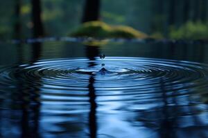 A serene close-up of a water droplet creating ripples on a calm surface, showcasing a tranquil forest setting. photo