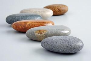 A collection of smooth, polished stones in various colors arranged in a pleasing pattern. photo