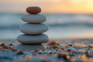 A serene stack of smooth pebbles on a sandy beach at sunset, symbolizing balance and tranquility. photo