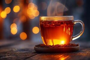 A steaming cup of tea placed on a wooden surface, surrounded by warm, glowing bokeh lights. photo