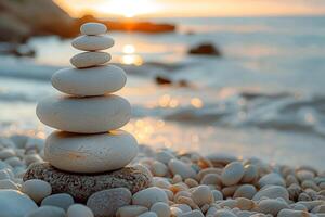 A serene stack of smooth pebbles on a beach at sunset, creating a tranquil and peaceful atmosphere. photo
