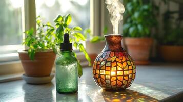 A soothing scene with a colorful essential oil diffuser and a green glass dropper bottle in a sunlit room. photo