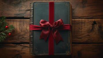 A beautifully wrapped vintage book tied with a red satin ribbon, evoking a warm holiday spirit. photo
