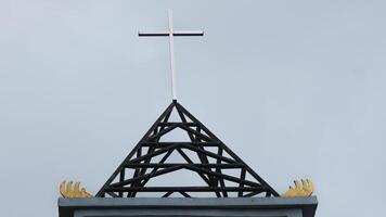 Symbol on the roof of the church, blue sky background. photo