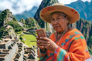 An Indigenous Peruvian woman in vibrant traditional attire using a smartphone at Machu Picchu, blending heritage with modern technology. photo