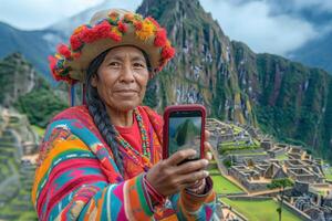 A smiling Indigenous woman in vibrant traditional attire holds a smartphone, capturing the breathtaking view of Machu Picchu. photo